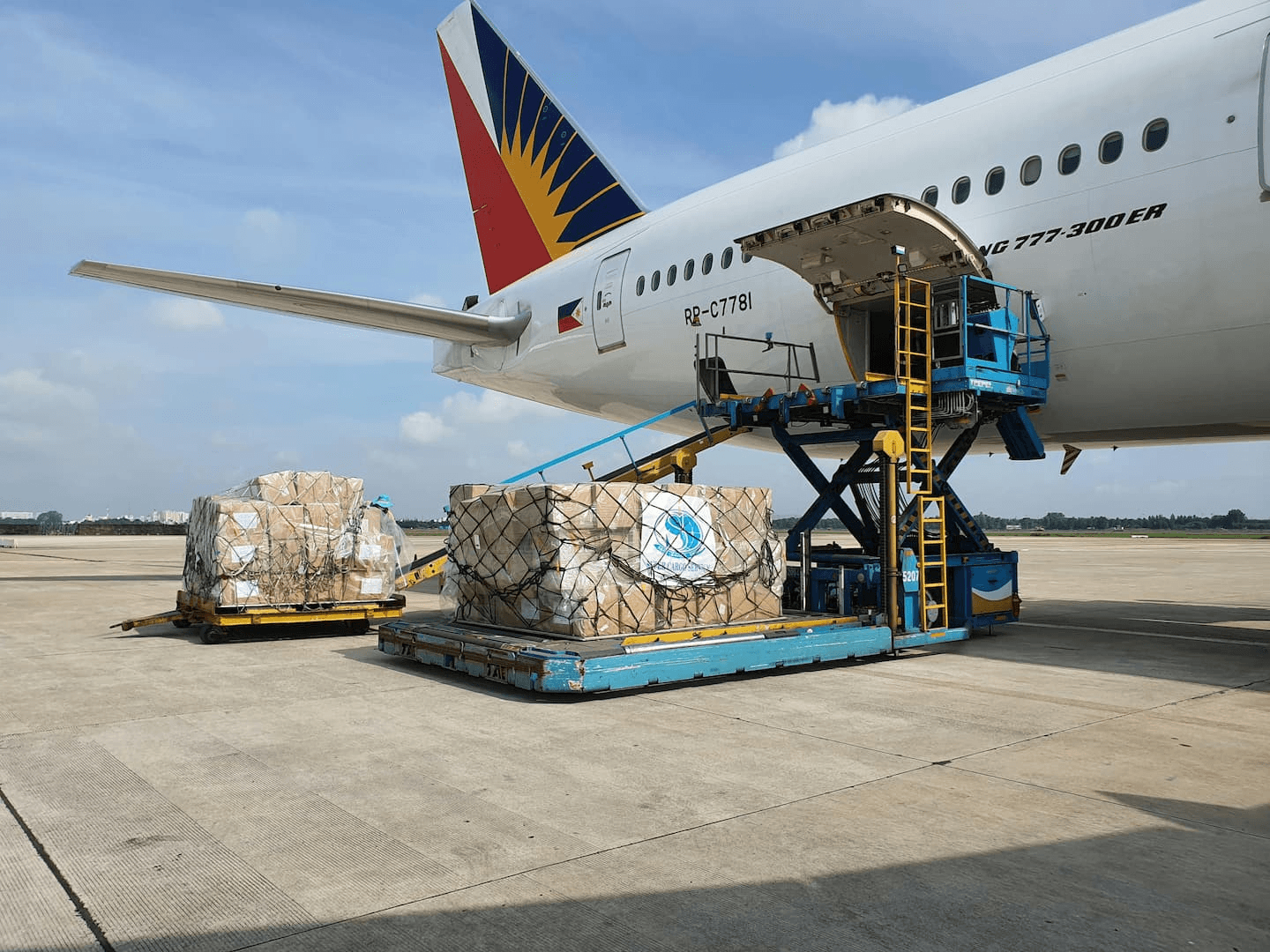Palletised cargo being loaded into a wide-body freighter