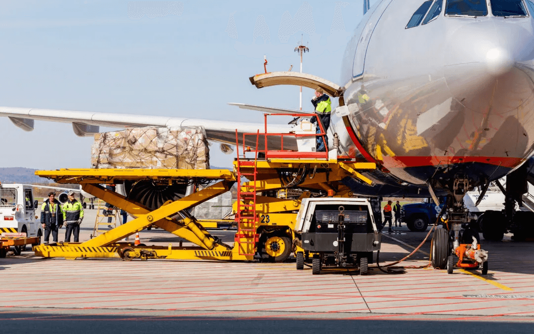 Ground crew loading cargo pallets onto an aircraft